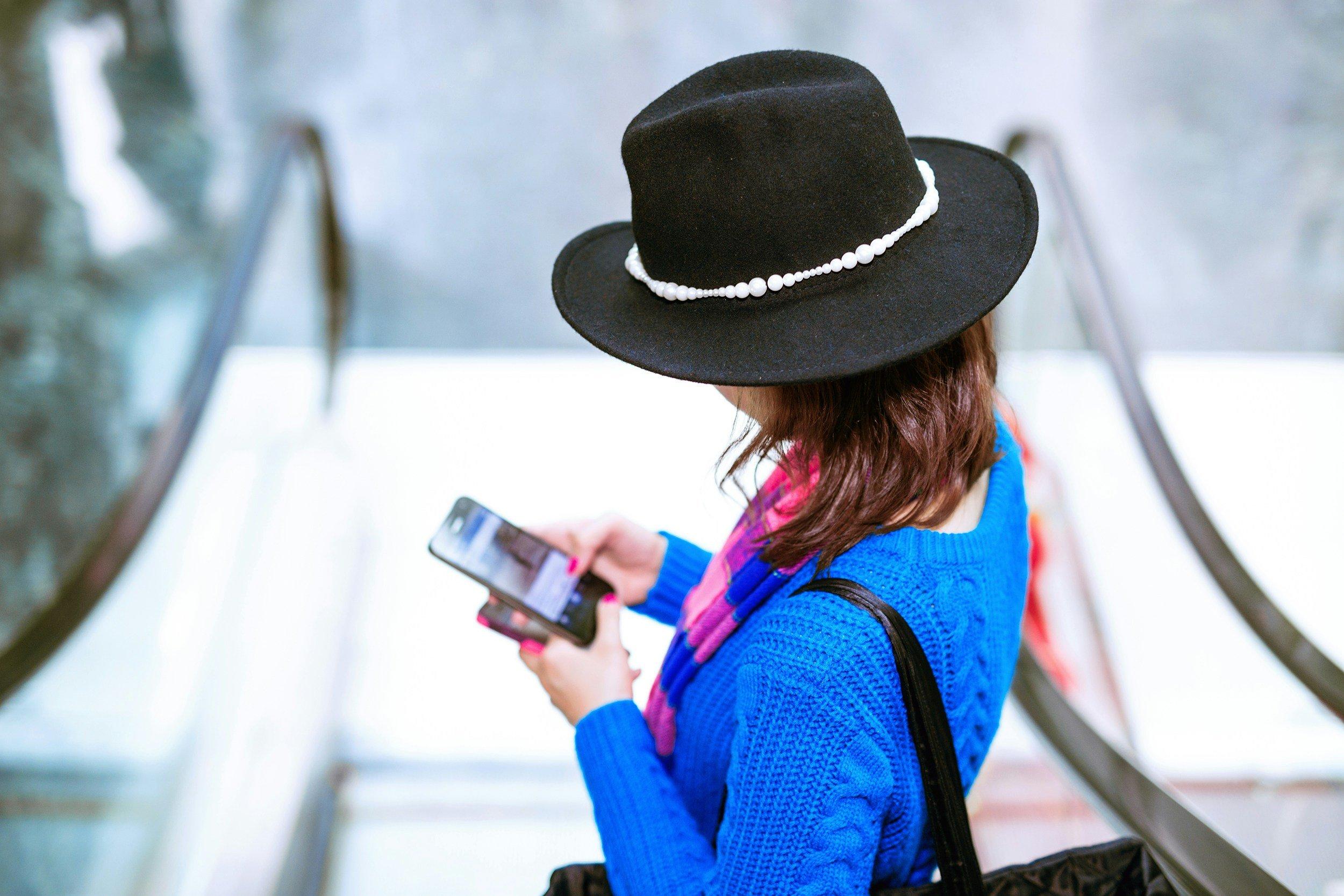 A stressed traveler sitting at an airport with luggage