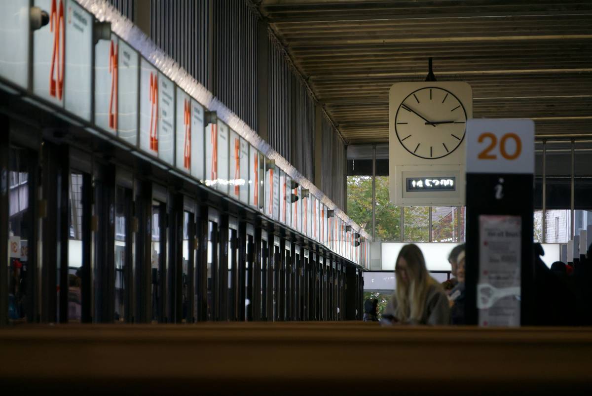 Luggage stacked at an airport carousel, representing delayed flights and potential insurance claims.